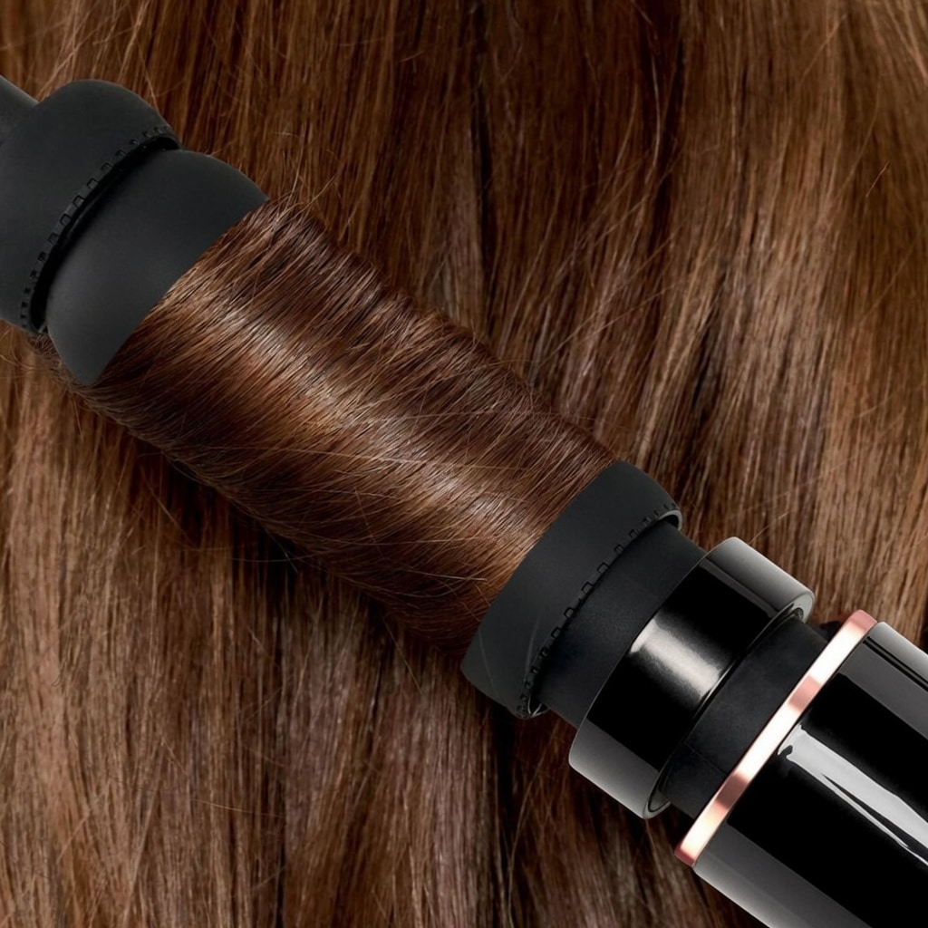 Airflow wrap curlers gathering hair around the barrel